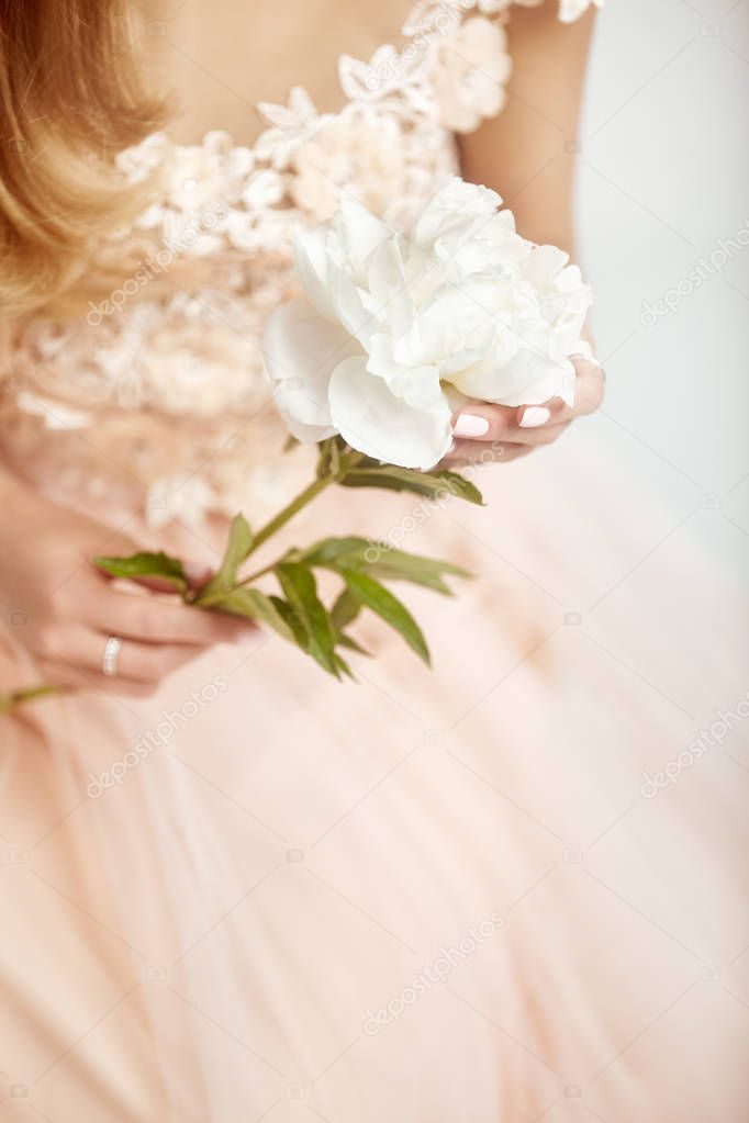 Beautiful Woman in Lace Wedding Dress.  Woman with a peony. Wedding Decoration