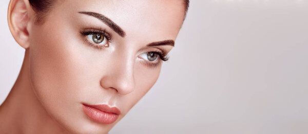 Beautiful woman with long false eyelashes