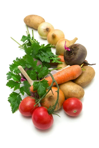 A small set of vegetables collected from garden beds on white background