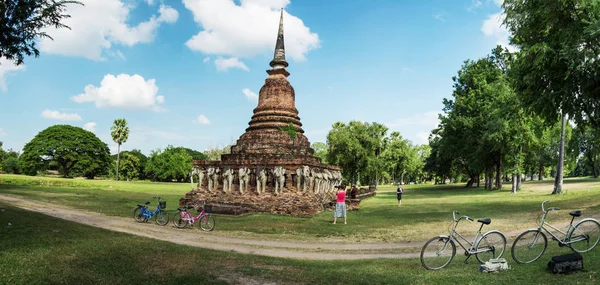 AYUTTHAYA , THAILAND - Circa Nov 2017: Tourists explore ancient ruins, using rented bicycles. Thailand