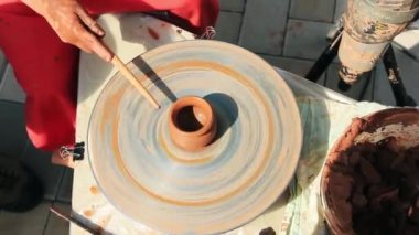 Çocuk bir çömlekçi tekerleği üzerinde çalışmayı öğreniyor, kil ile çalışıyor