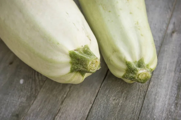 Two zucchini on a floor from old boards close-up — Stock Photo, Image