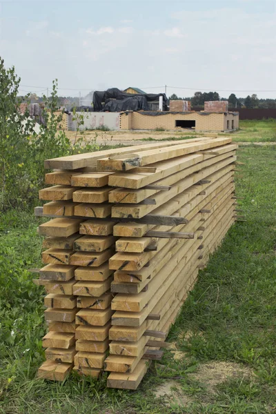Boards brought and stacked before construction of house — Stock Photo, Image