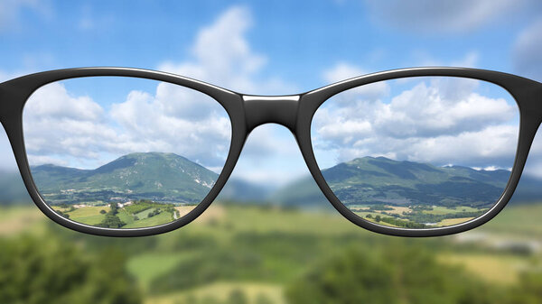 View through glasses on landscape with mountains 