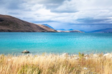 view of turquoise Lake Tekapo in New Zealand clipart