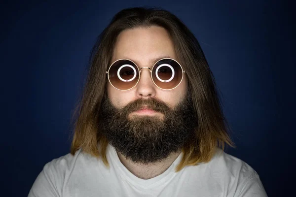 Bearded young man with long hair and sunglasses — Stock Photo, Image