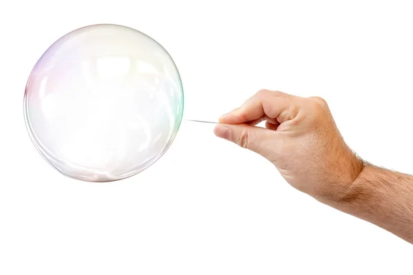 Soap bubble and a males hand with needle to let it pop — Stock Photo, Image