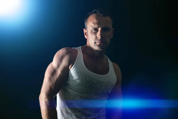 Handsome muscle man blue light — Stock Photo, Image