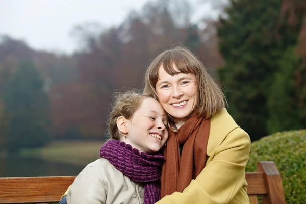 Buiten portret van lachende vrouw en meisje — Stockfoto