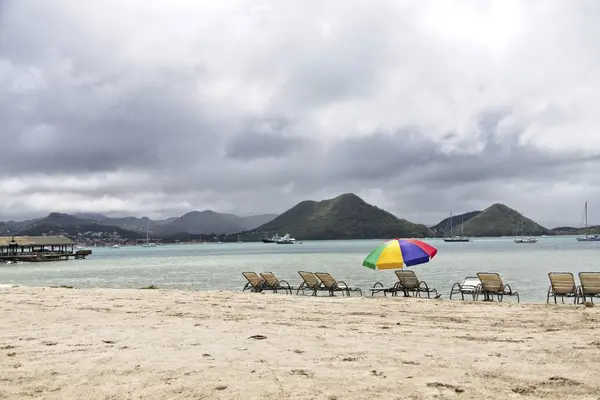 Chaise Lohes and Beach Umbrella — стоковое фото