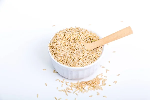 Brown Rice in a White Bowl with Wood Spoon — Stock Photo, Image