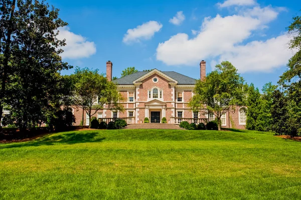 Yeşil çimenli tepe üzerinde kırmızı tuğla mansion