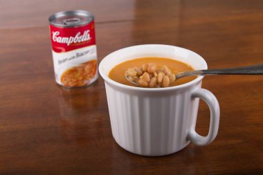 Spoon and Mug of Bean and Bacon Soup clipart
