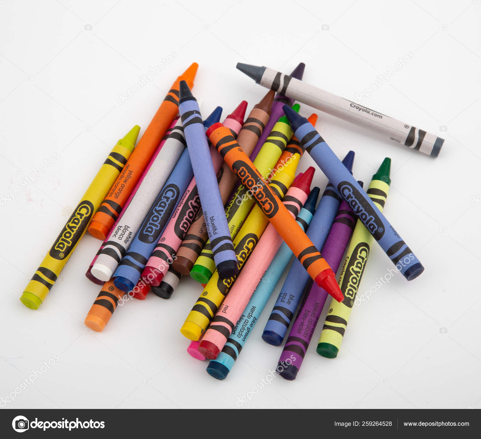 Row Of Bright Crayolas Pointing Downwards On White Stock Photo