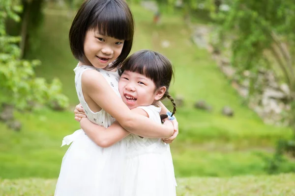Cute Sisters Playing Hugging Garden Park Asian Family Outdoors Portrait — Stock Photo, Image
