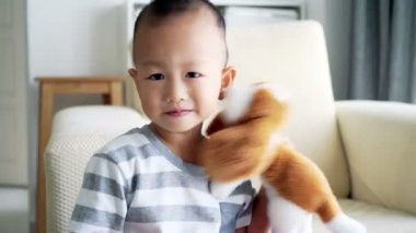 İki ya da üç yaşında çocuk oyuncakları oynarken ve kanepe, oturma odası gündüz kitap okuma.