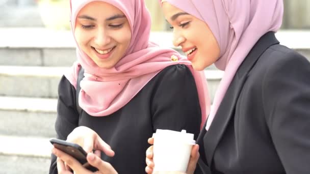 Muslim Women Using Smart Phone Sharing Laughing — Stock Video