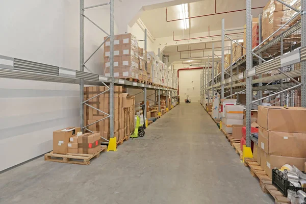 Boxes at Shelves in Long Storage Room Warehouse