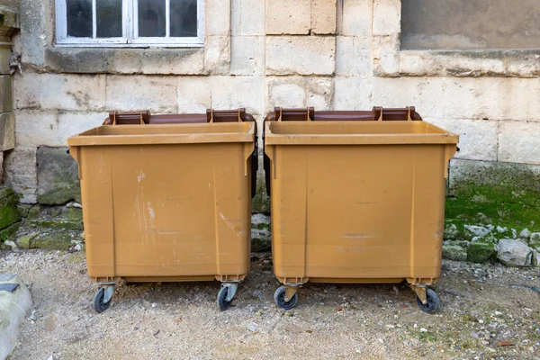 Two Brown Dumpsters