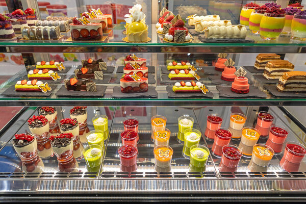 Assortment of Pastries and Cakes in Patisserie Display