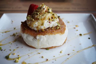 Lübnanlı bir tatlı ashta ve vanilyalı dondurma ile antep fıstığı yapılmış ve bal ile drizzled.