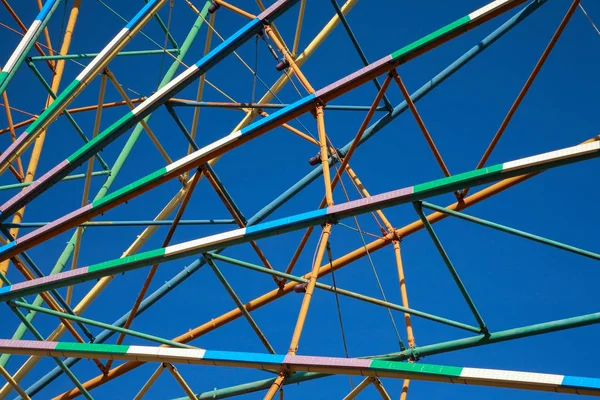 Metal constructions against the blue sky, multicolored