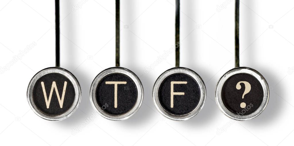 Four old, scratched chrome typewriter keys with black centers and white letters spelling out 