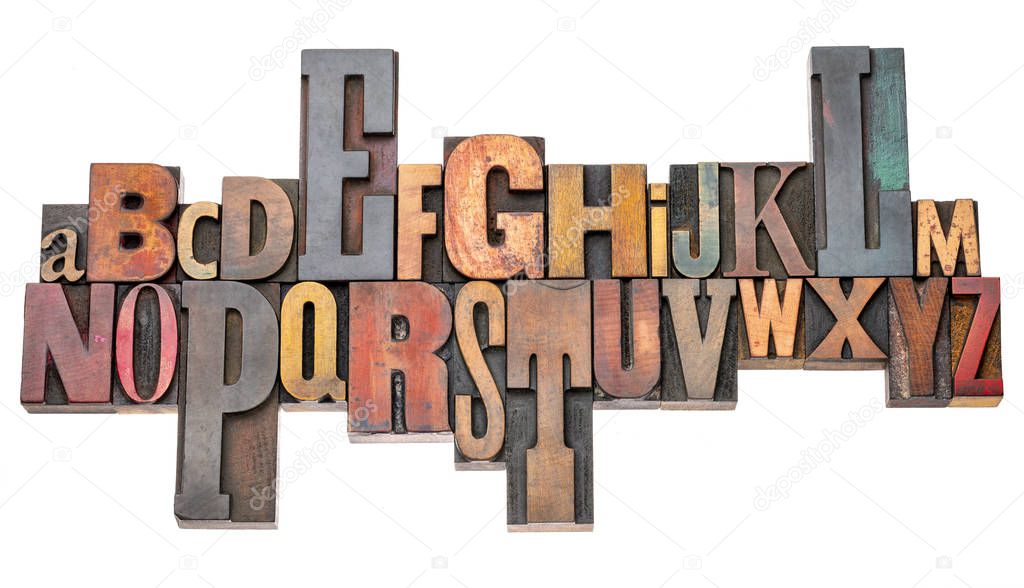 isolated alphabet abstract in vintage letterpress wood type blocks stained by color inks