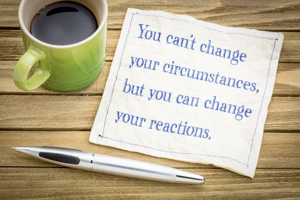 You can not change your circumstances, but  you can change your reactions - inspiraitonal handwriitng on a napkin with a cup of coffee