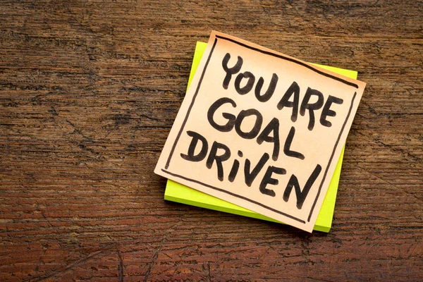 You are goal driven - positive affirmation - handwriting on a sticky note agianst rustic wood