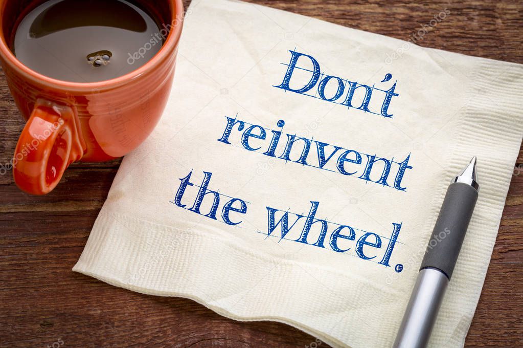 Do not reinvent the wheel - handwriting on a napkin with a cup of coffee