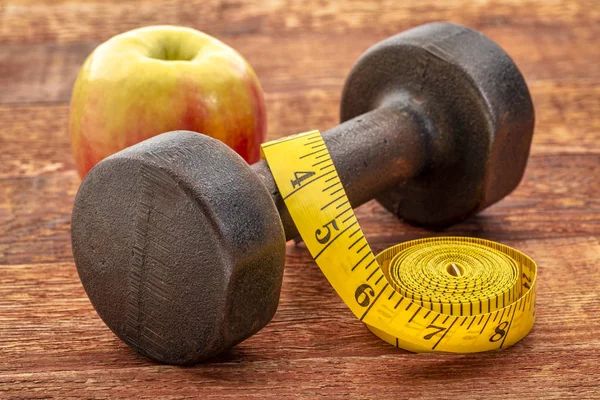 Vintage Rusty Iron Dumbbell Tape Measure Apple Grained Wood Background — Stock Photo, Image