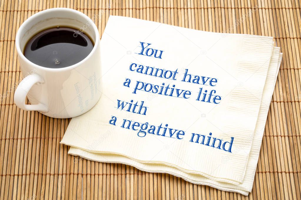 You cannot have a positive life with a negative mind - inspiraitonal text on a napkin with a cup of coffee