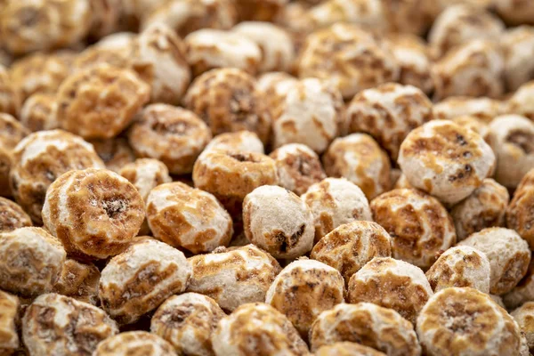 organic peeled tiger nuts, a rich source of resistant starch, top view background with selective focus