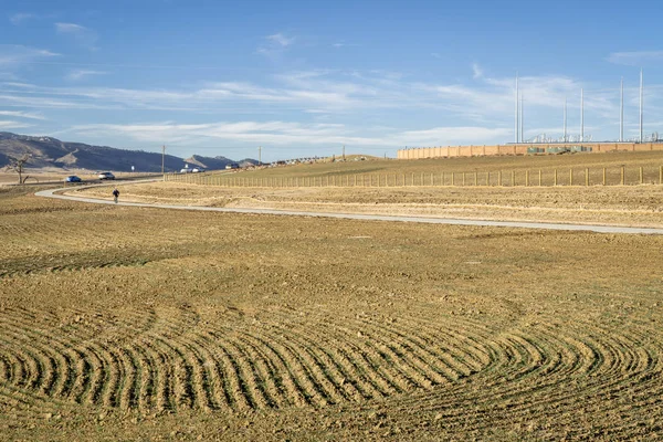 Newly constructed bike trail at foothills of northern Colorado with farmland and power lines