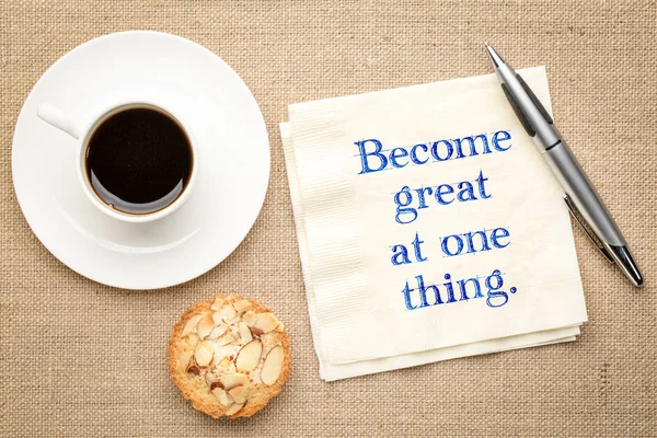 Become great at one thing - inspirational handwriting on a napkin with a cup of coffee