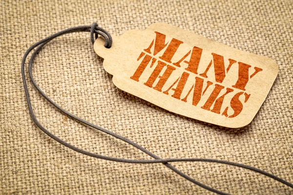 many thanks  sign - a paper price tag with a twine iagainst burlap canvas
