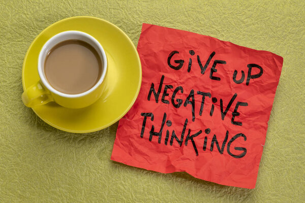 give up negative thoughts - reminder note with a cup of coffee
