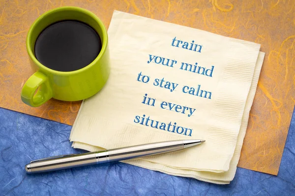 train your mind to stay calm in every situation - inspirational handwriting on a napkin with a cup of coffee