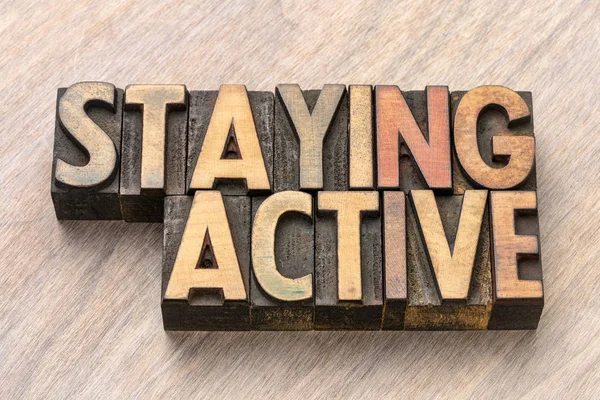 staying active word abstract  in vintage letterpress wood type printing blocks