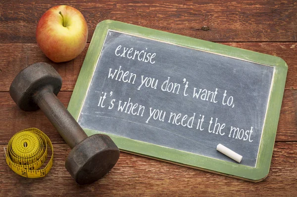 exercise when you don\'t want to, it\'s when you need it the most - white chalk text on a slate blackboard against weathered red painted barn wood