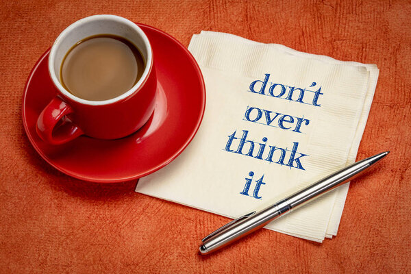 do not overthink it advice - handwriting on a napkin with a cup of coffee
