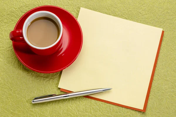 square blank yellow note with a cup of espresso coffee and pen
