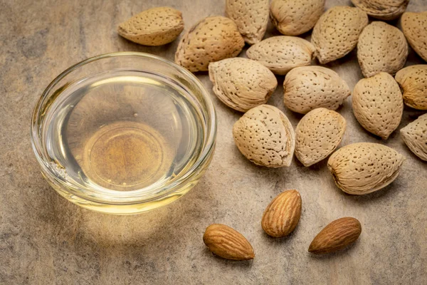 Almond nuts and oil — Stock Photo, Image