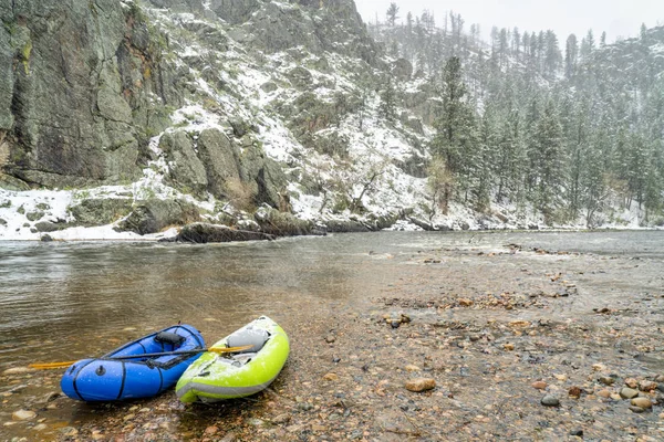 Inflatable whitewater kayak and packraft in snowstorm — Stock Photo, Image