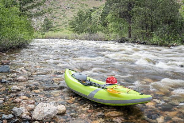 inflatable whitewater kayak on mountain river