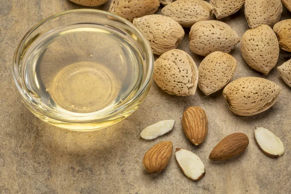 Almond nuts and oil — Stock Photo, Image