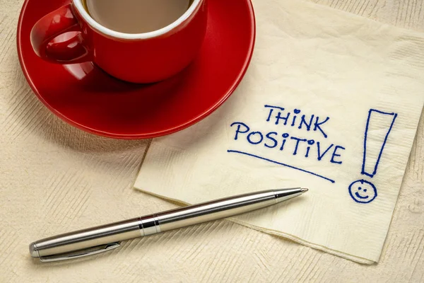 Think positive  reminder on a napkin — Stock Photo, Image