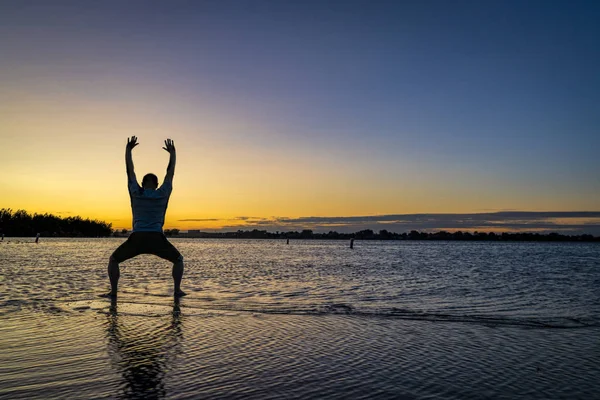 Sunrise silhuett av en man på en sjö — Stockfoto