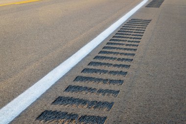 safety rumble strips on a highway shoulder  clipart
